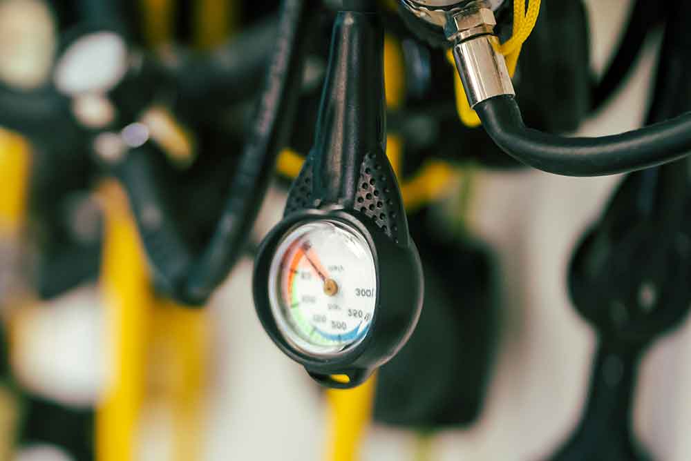 62329960_a-diving-equipment-with-regulators-and-tools-for-checking-barrels a-diving-equipment-with-regulators-and-tools-for-checking-barrels.