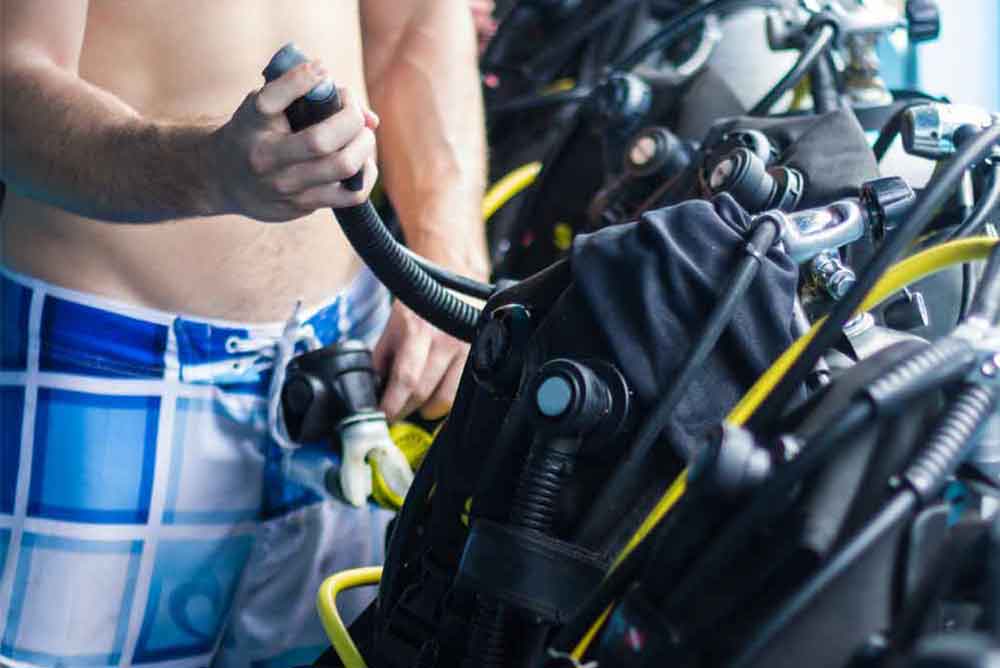 Buoyancy Control Device (BCD) a-diving-equipment-with-regulators-and-tools-for-checking-barrels.
